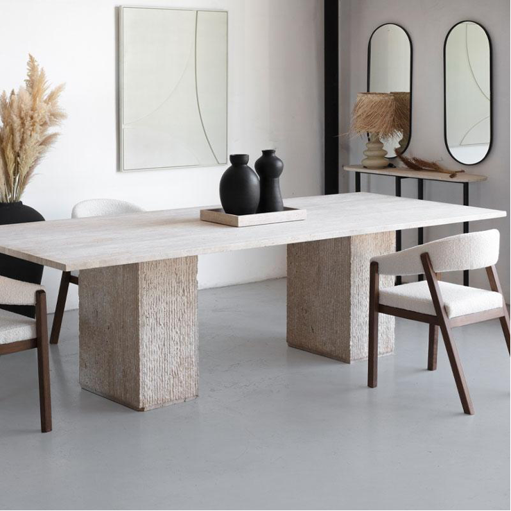 Table rectangulaire en travertin avec pieds martelés, design brut et raffiné.